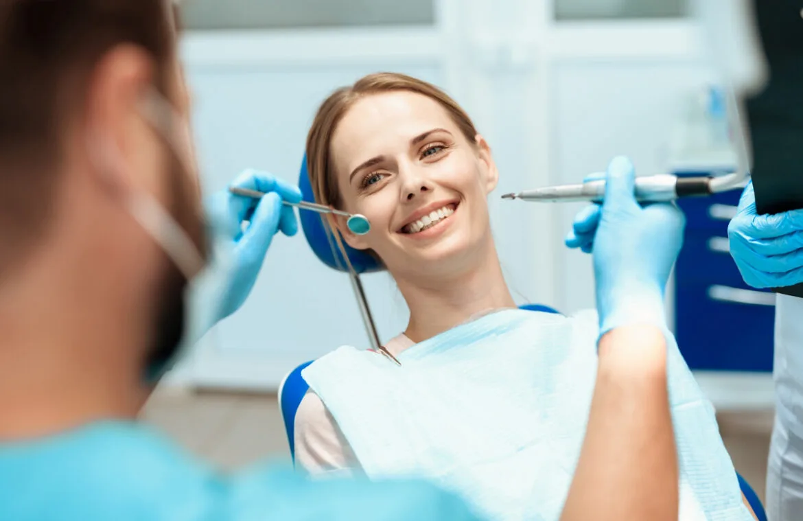 Simpladent Clinics Visakhapatnam - Dental Implants woman sits dental chair doctors bowed her